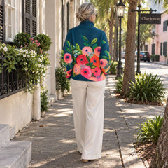 Woman walking on a Charleston street showing the floral pattern on the back of the Alice sweater